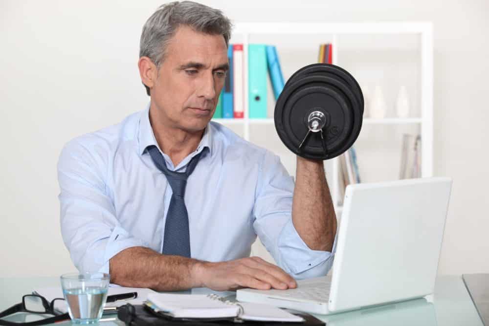 businessman making exercises in his office