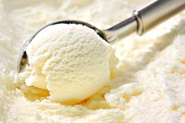 Vanilla ice cream scooped out of container